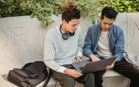 A graduate student reviews financial aid documents as federal loan 