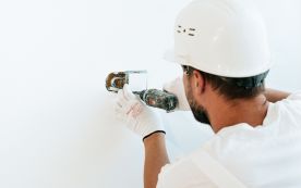 A Man Fixing a Switch
