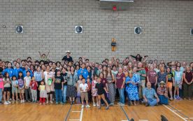 Students and local Anza church members pose for a group 