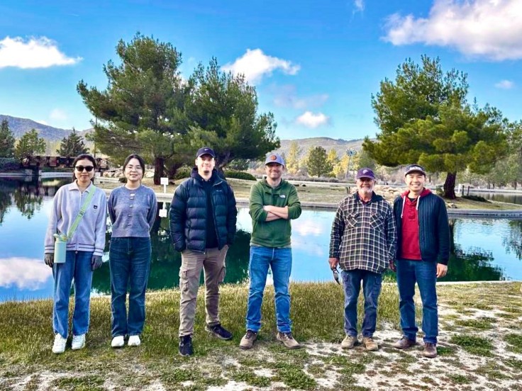 Volunteers pose in front of the Pathfinder Ranch's Lied Lake
